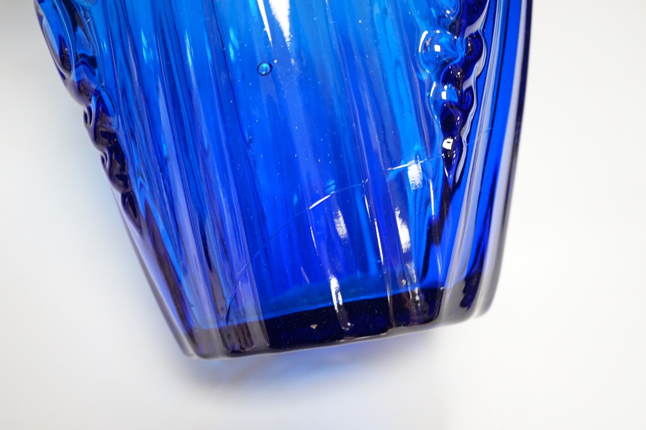 An Art Deco blue floral moulded glass vase. 31cm tall